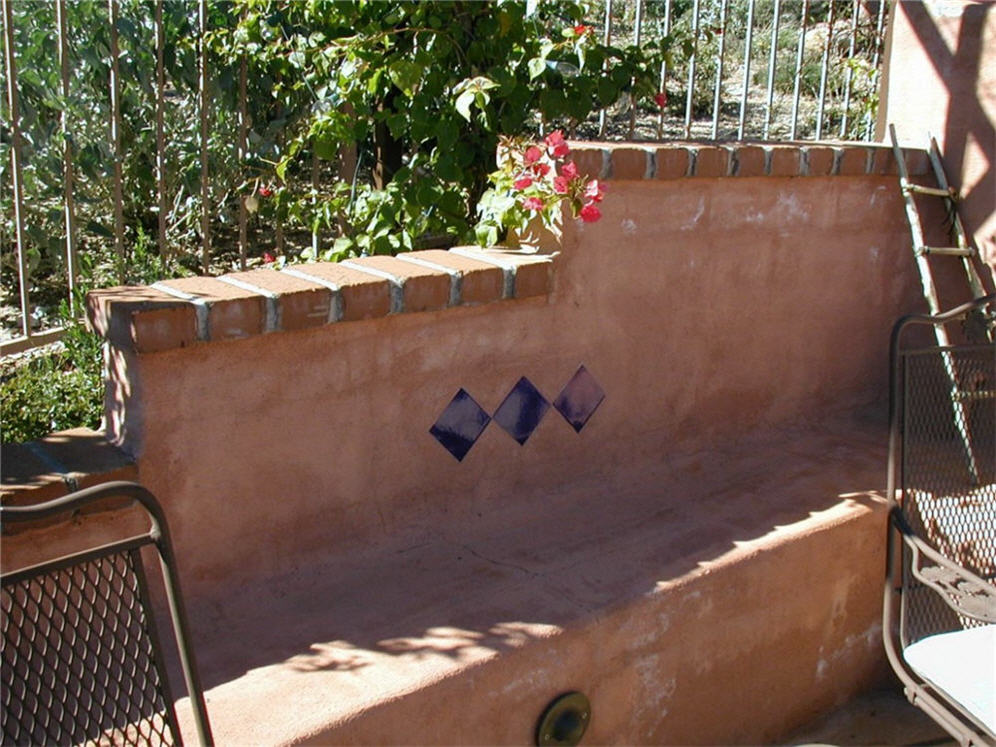 Red Stucco Wall with Brick Cap